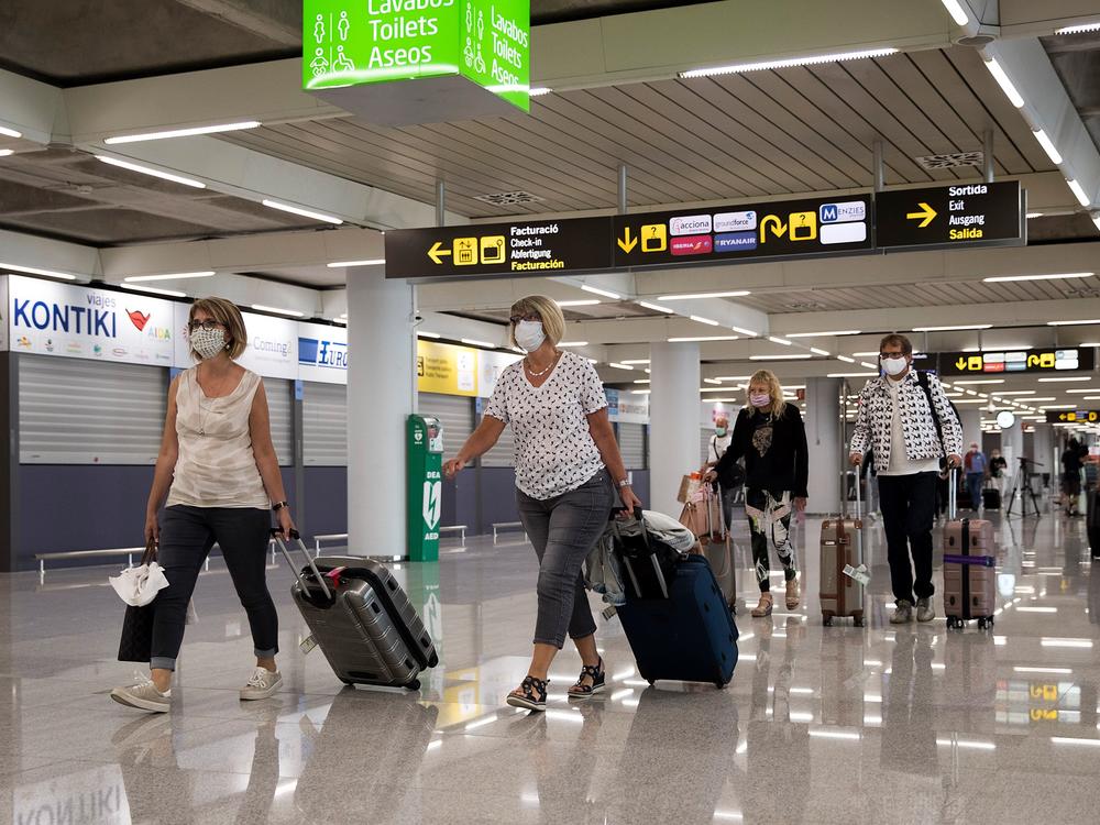 Tourists arrive at Palma de Mallorca, Spain, last summer. The EU's executive arm has proposed a certificate to ease travel across its member states.