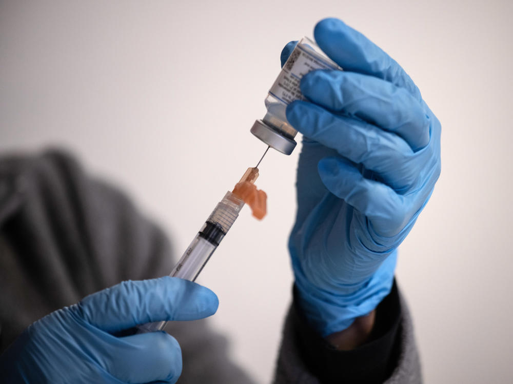 Nurse manager Lucy Golding draws up doses of the Moderna COVID-19 vaccine March 14 in Stamford, Conn. Moderna has begun enrolling infants and young children into a vaccine trial.