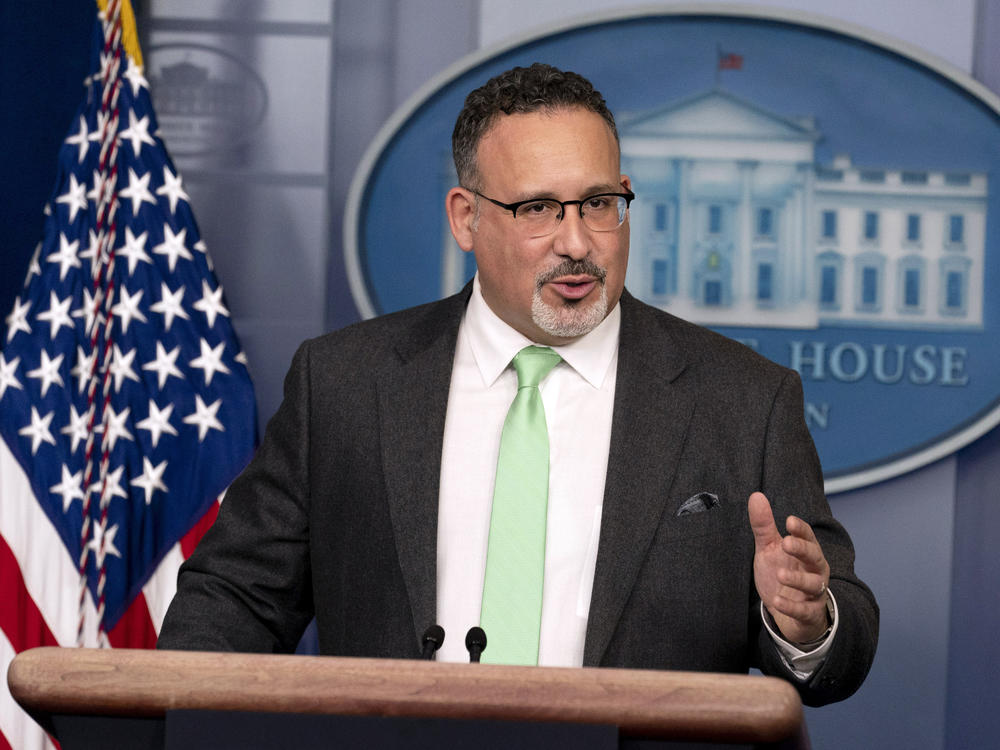 U.S. Education Secretary Miguel Cardona speaks at the White House on Wednesday. The Department of Education says it is scrapping a controversial, Trump-era policy that granted only partial student loan relief to borrowers who were defrauded by private, for-profit colleges.
