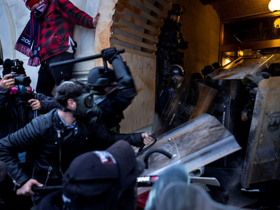 Rioters clash with police and security forces as people try to storm the U.S. Capitol on Jan. 6. The FBI is undertaking an extensive investigation to identify and charge hundreds of individuals.