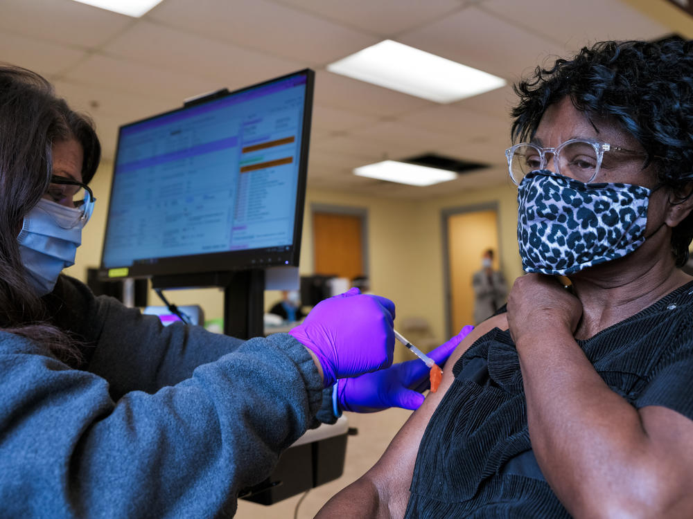 A woman receives the Moderna COVID-19 vaccine at the Bates Memorial Baptist Church in Louisville, Ky., on Feb. 12. Yet in many states, there are racial disparities in who has received the shot.