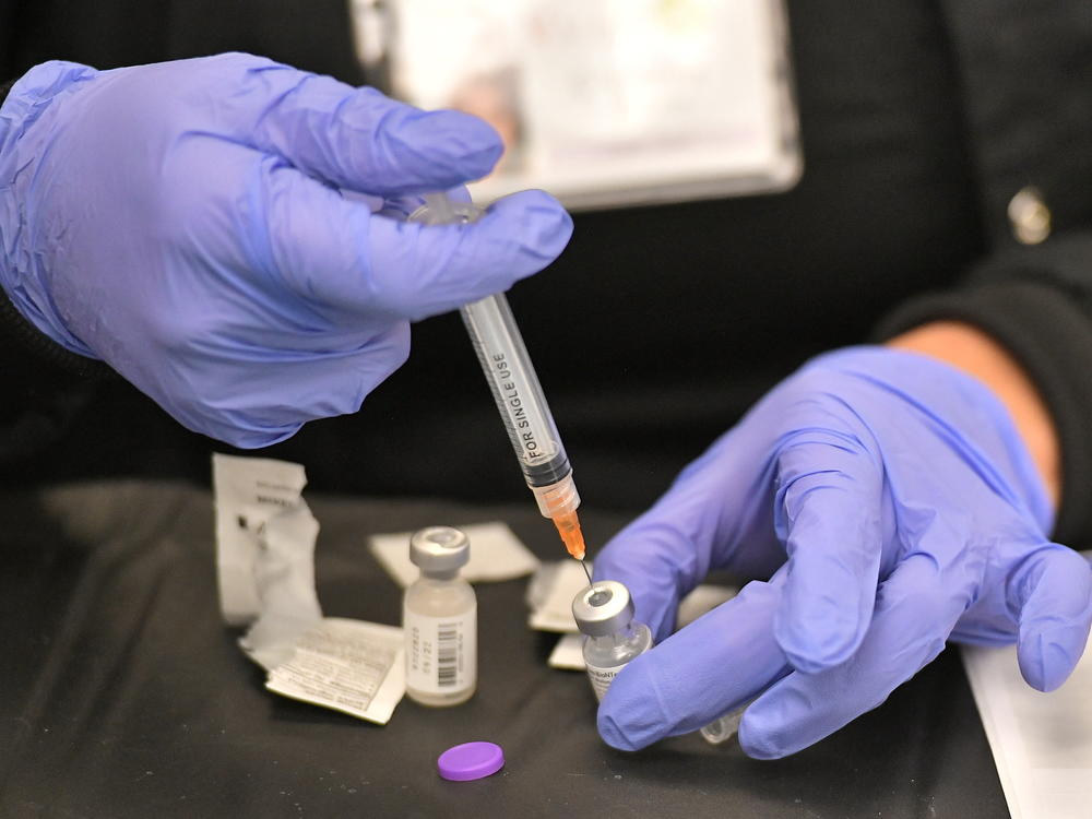 A health worker prepares a dose of the Pfizer BioNTech vaccine at a COVID-19 vaccination site at the University of Nevada in Las Vegas on March 15.