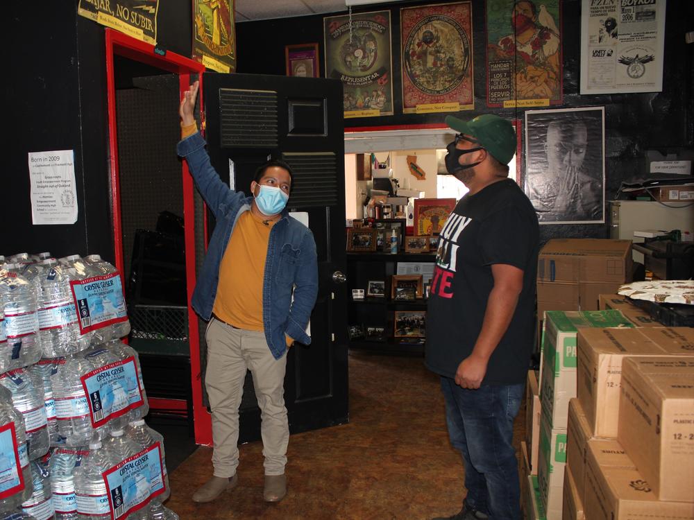 Radio B'alam founders Henry Sales and Crecensio Ramirez check out Radio B'alam's sound booth at Homies Empowerment the day before the shows first broadcast, December 2020.