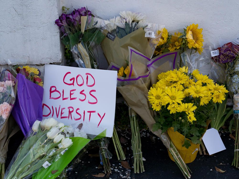Flowers and signs adorn Gold Spa in Atlanta during a demonstration on Thursday opposing violence against women and Asians following this week's deadly shootings in the area.