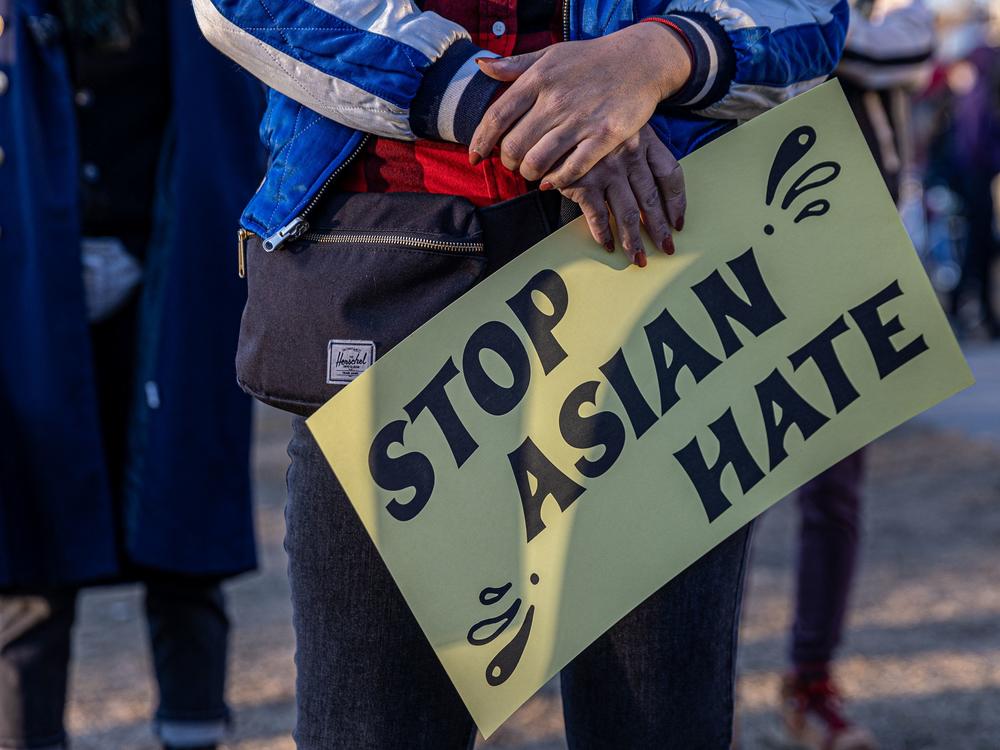 A person holds a sign during the 