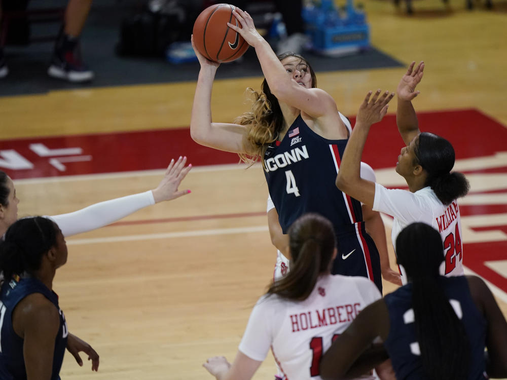 Connecticut guard Saylor Poffenbarger (4) is defended by St. John's guard Danaijah Williams (24) and forward Cecilia Holmberg (11) during the fourth quarter of an NCAA college basketball game in New York last month. The women's NCAA championship begins Sunday.