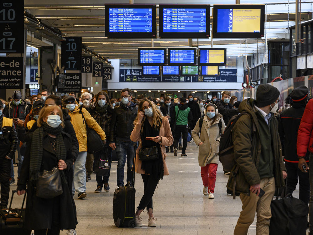 Travelers waited to flee Paris at the Montparnasse Train Station on Friday ahead of a new lockdown announced by the government in response to a surge in cases of the coronavirus.