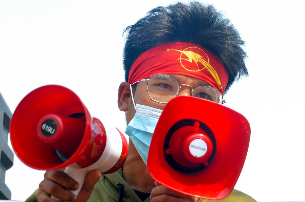 A protester wearing a headband featuring a students' union logo addresses a crowd during a demonstration against the military coup in Naypyidaw, Myanmar, on Feb. 28.
