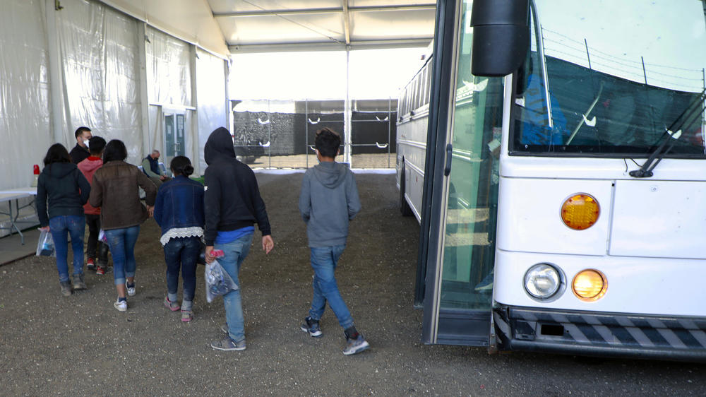 Children and families arrive at a temporary processing facility in Donna, Texas, on March 17.
