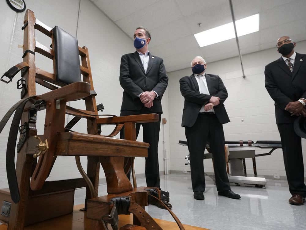 Virginia Gov. Ralph Northam (left) looks over the electric chair in the death chamber at the Greensville Correctional Center with Operations Director George Hinkle (center) and the director of the Department of Corrections, Harold Clarke, prior to signing a bill abolishing the penalty Wednesday.