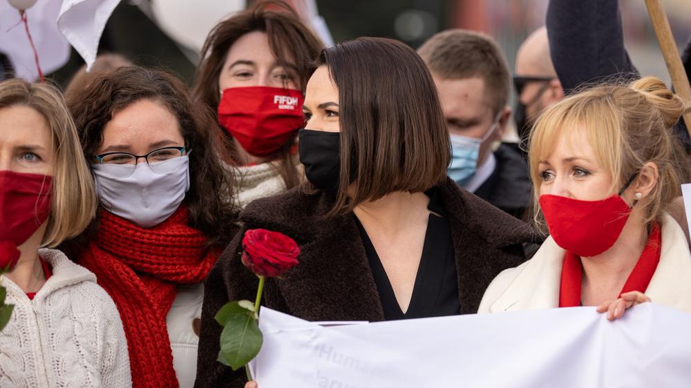 Tikhanovskaya (center, black mask) takes part in a demonstration on the Place des Nations in front of the Palais des Nations in Geneva on March 7.
