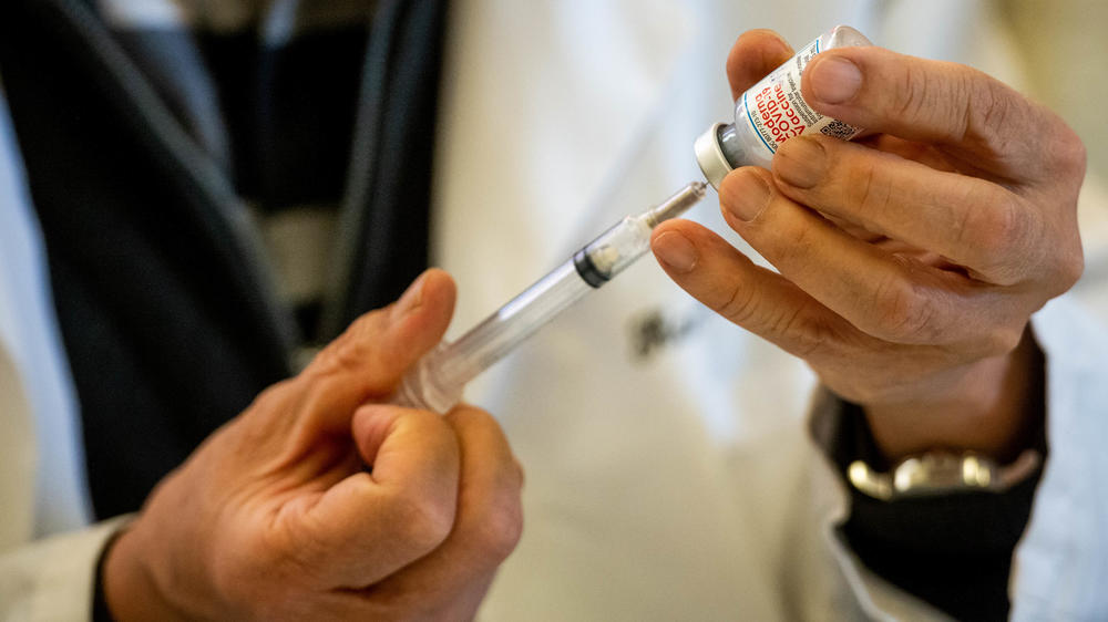 A doctor fills syringes with the Moderna COVID-19 vaccine this week at the San Gabriel Mission Playhouse in San Gabriel, Calif.