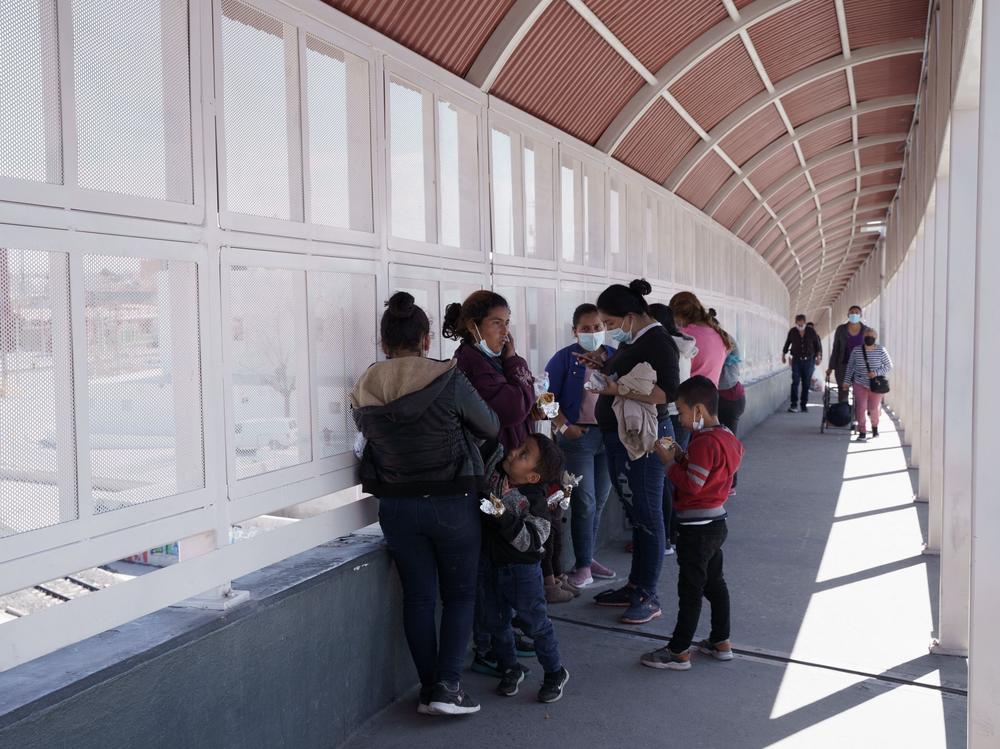 A group of migrants rapidly deported from the U.S. under Title 42 wait on the Mexican side of the Paso del Norte International Bridge, between El Paso, Texas and Ciudad Juarez, Mexico on March 10.