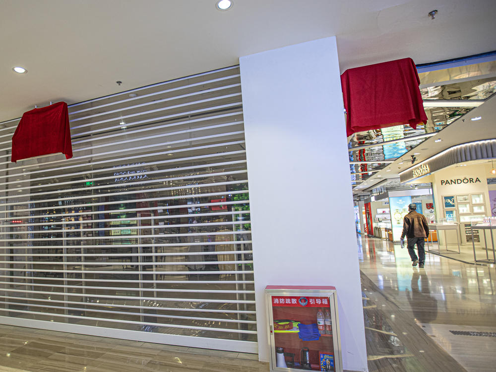 H&M logos are covered by red cloth at a closed store Thursday in Urumqi in China's Xinjiang Uyghur Autonomous Region.