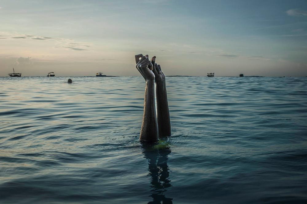 Swim instructor Chema snaps her fingers as she disappears underwater on Dec. 28, 2016, in Nungwi, Zanzibar. 