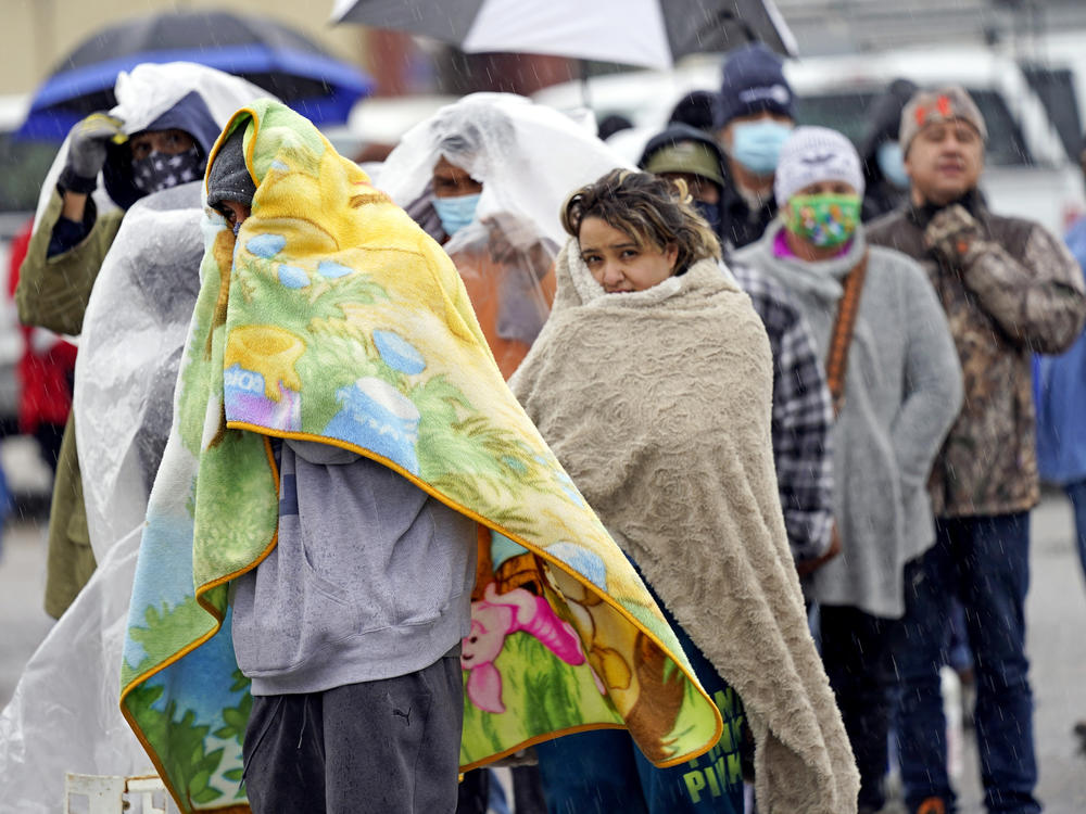 People wait in line to fill propane tanks on Feb. 17 in Houston. Power grid problems left millions weathering conditions in the dark in uninsulated homes, intensifying the Texas winter storm's deadliness.