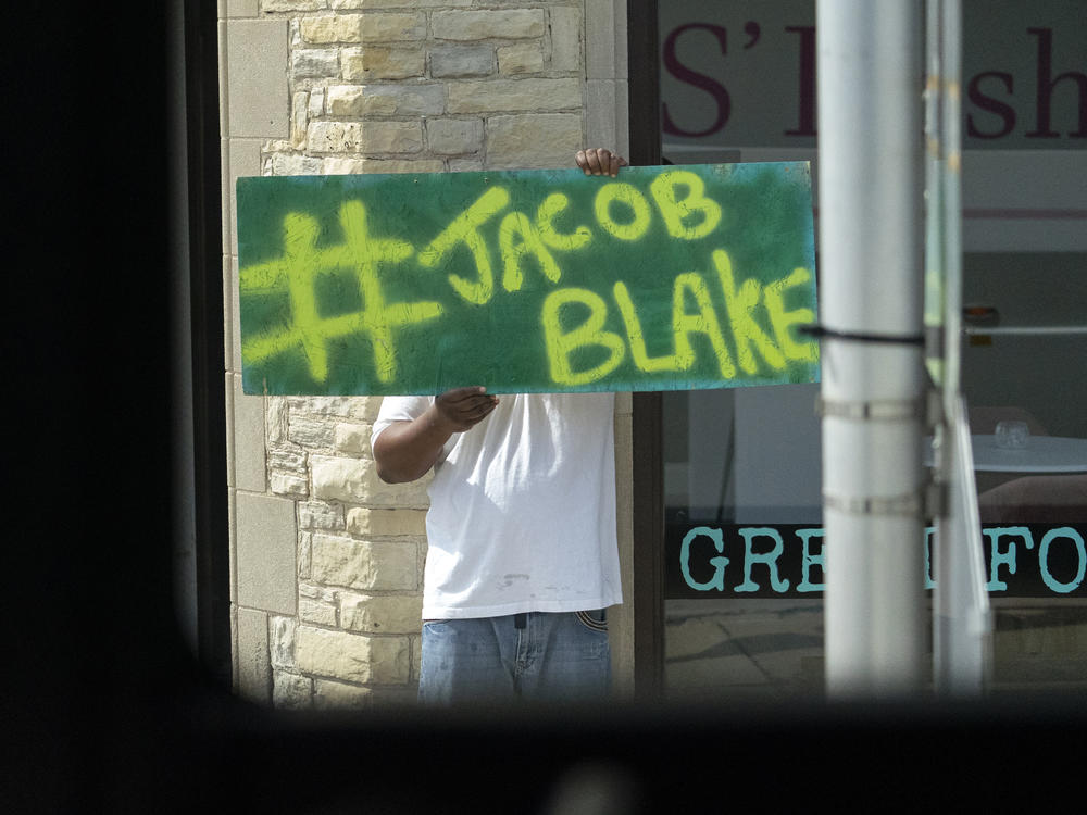 A Jacob Blake sign was on display as the motorcade of then-presidential candidate Joe Biden passed by in Kenosha Wis., on Sept. 3, 2020. A team of attorneys representing Blake have filed an excessive force lawsuit against the officer who shot and paralyzed him in August.