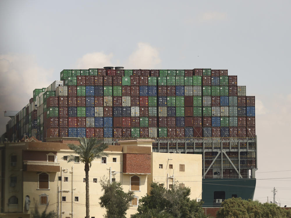 The Panama-flagged Ever Given is seen wedged across the Suez Canal on Friday. Tugboats, dredgers and even land-based, earth-moving equipment were pressed into service to try to free the 1,300-foot container ship.