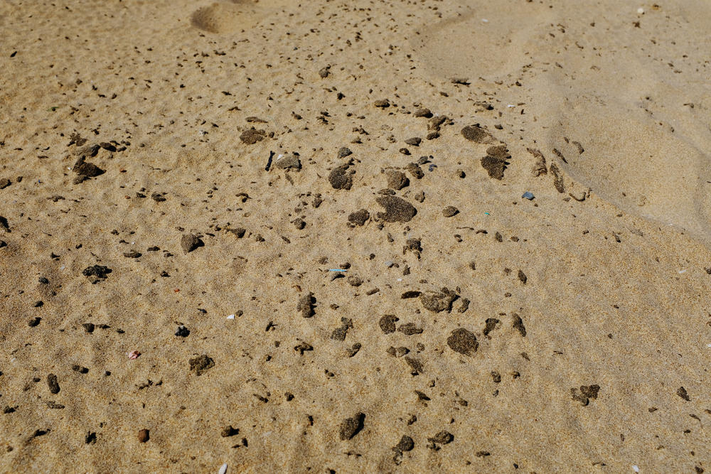 Tyre beach is carpeted in globs of<strong> </strong>poisonous tar. As weeks pass, the soft black pieces fragment into smaller particles that sink deeper into the sand.