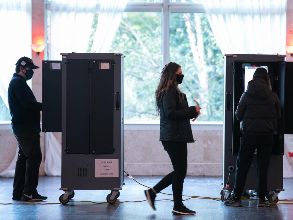 Voters in Atlanta casting their ballots on voting equipment made by Dominion Voting Systems. After losing the election, former President Trump and his allies spread conspiracy theories about the company, which has responded with defamation suits to combat the disinformation.