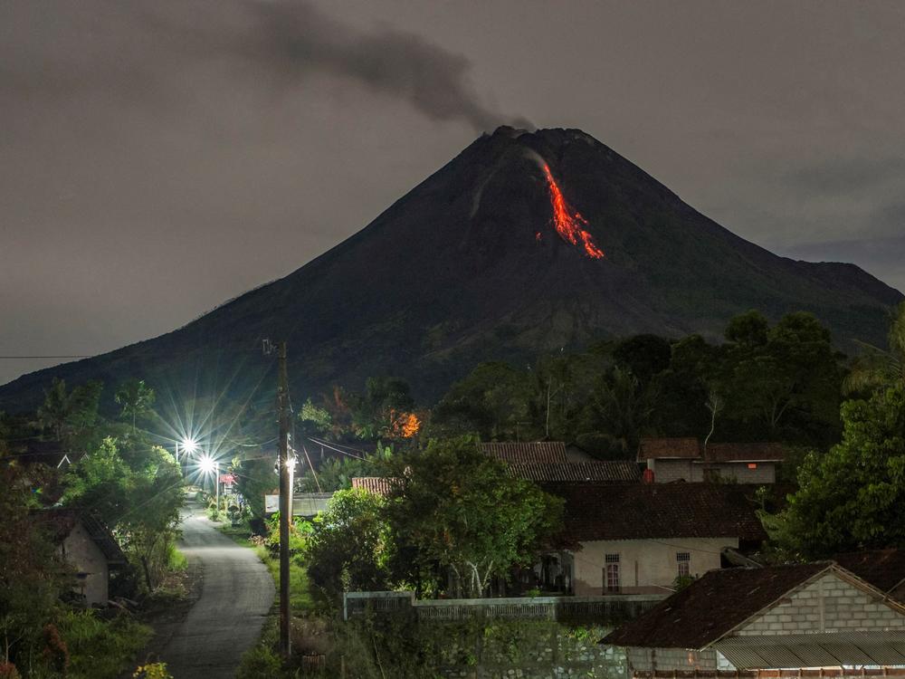 Lava flows down from the crater of Mount Merapi, Indonesia's most active volcano, as seen from Tunggul Arum in the city of Turi near Yogyakarta early Saturday.