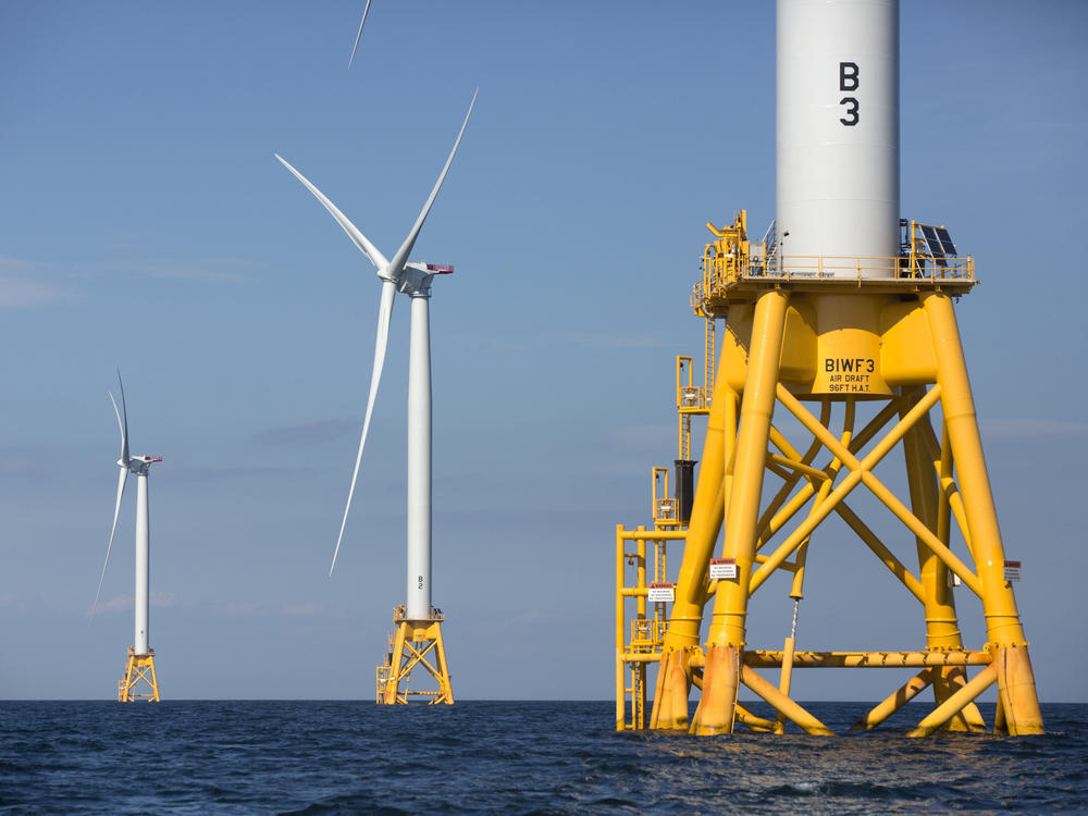 Three of Deepwater Wind's turbines stand off Block Island, R.I., in 2016. The Biden administration is pushing for a sharp increase in offshore wind energy development along the East Coast.
