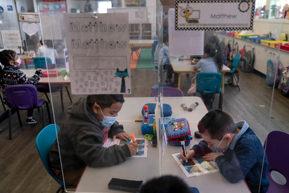 Pre-kindergarten students work on their school work at West Orange Elementary School in Orange, Calif. The Centers for Disease Control and Prevention relaxed its social distancing guidelines for schools on March 19, saying students can now sit 3 feet apart in classrooms.