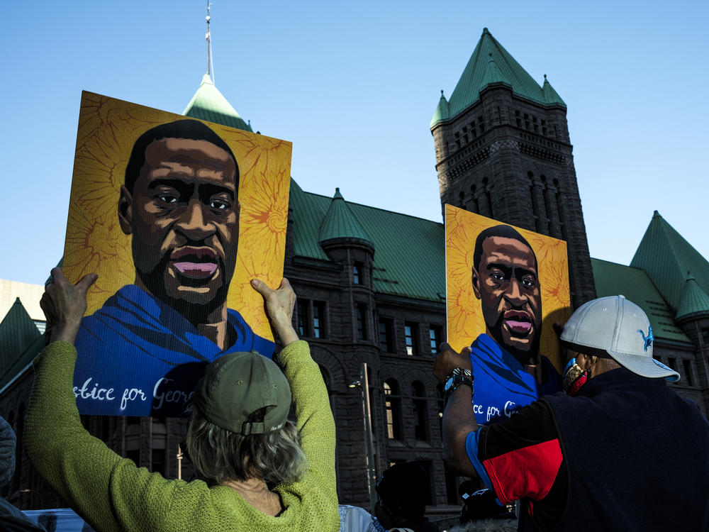 People gather during a demonstration outside the Hennepin County Government Center in Minneapolis on Monday as opening statements were given in the trial of former Minneapolis police officer Derek Chauvin, charged in the killing of George Floyd.