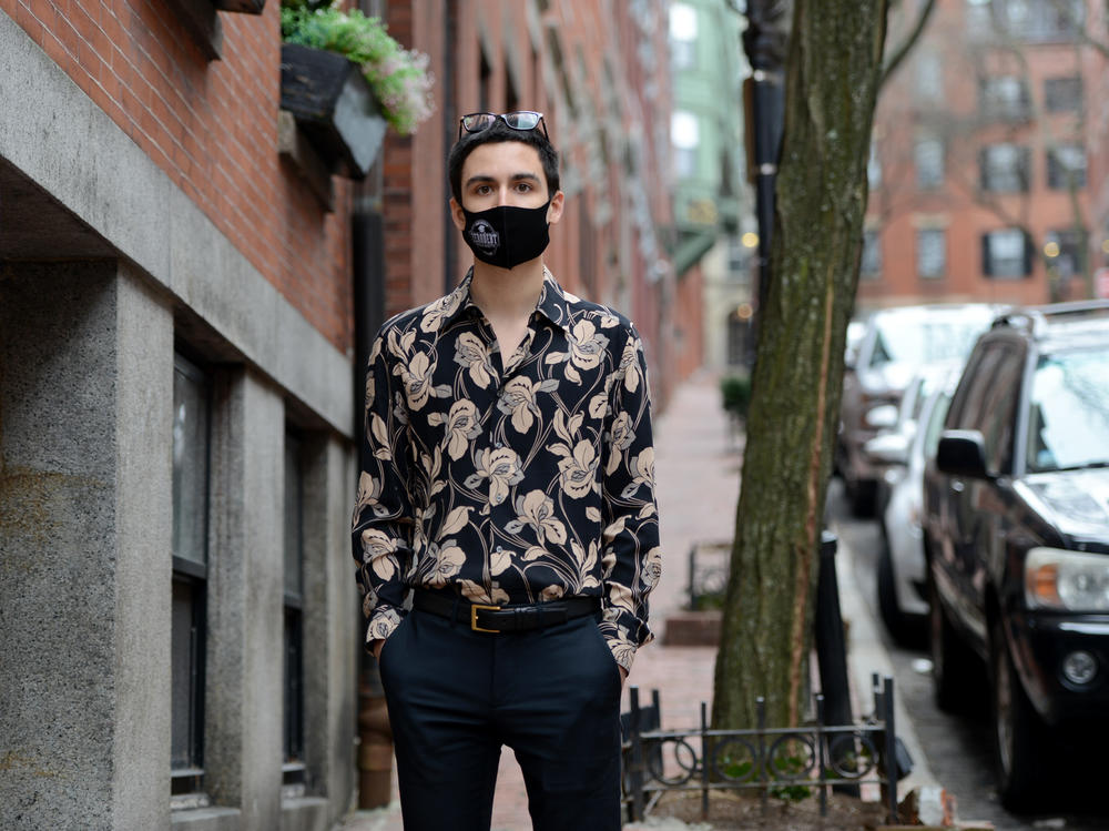 Gabriel Toro, 23, stands on the sidewalk near his apartment in Boston on March 11. Toro completed the credits required for a bachelor's degree from the University of Massachusetts Boston but the school wouldn't release Toro's transcript or degree because of an unpaid balance.