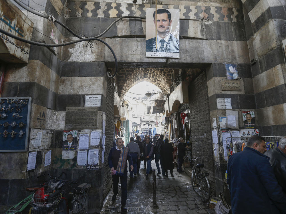 Syrians commute through one of the capital city's historic gates in Damascus' old town in March. Danish authorities are reevaluating the status of some Syrian asylum seekers after concluding that the security situation in parts of Syria has improved.