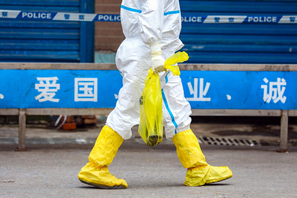 A worker who was part of the cleanup effort at the Huanan Seafood Market carries an escaped giant salamander, one of many types of live animals on sale. The photo was taken on Jan. 27, 2020.