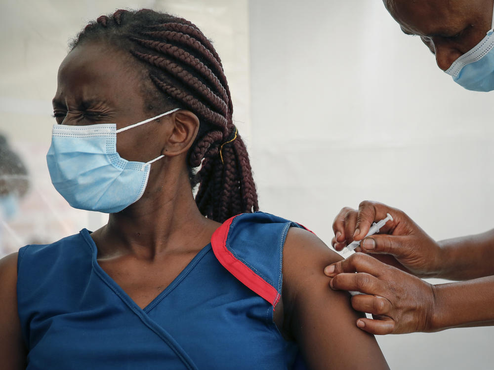 A front-line worker in Kenya receives a shot of the AstraZeneca COVID-19 vaccine. African Family Holistic Health Organization in Portland, Ore., hopes that the work it does in the U.S. will help curb vaccine misinformation back in Africa.