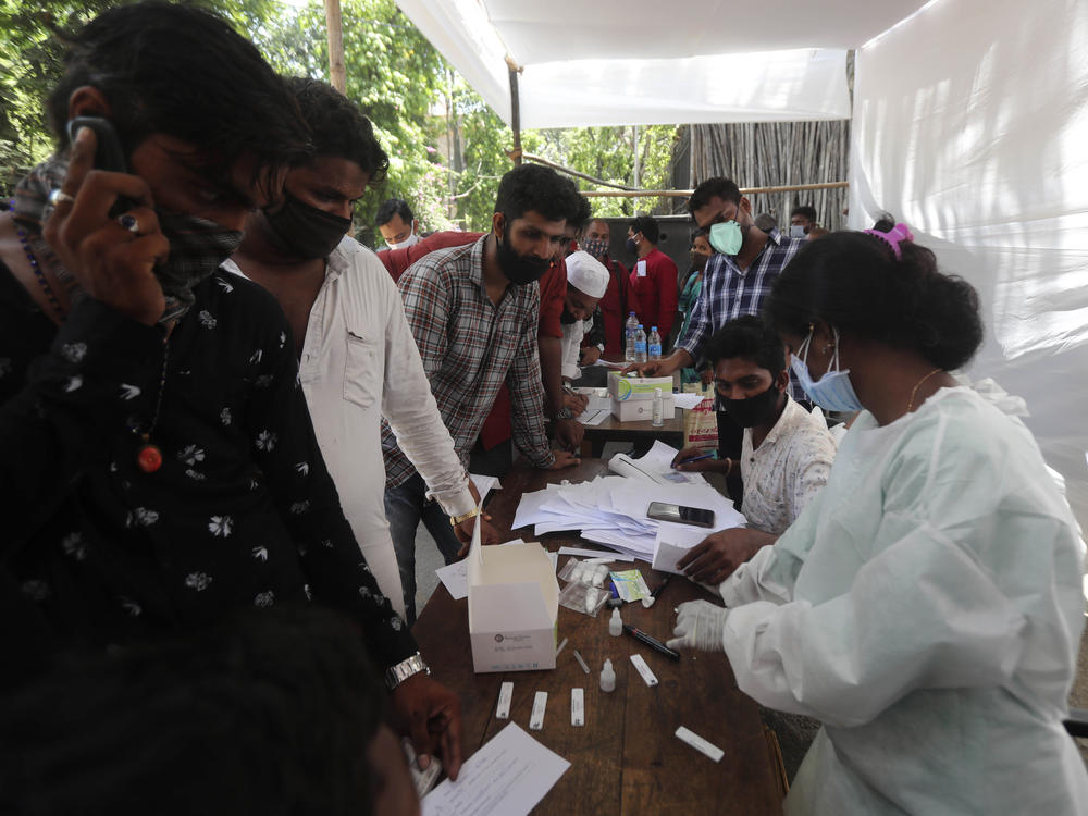 People wait for coronavirus tests outside a court in Mumbai on Monday as India reported its biggest single-day spike in confirmed coronavirus cases since the pandemic began.