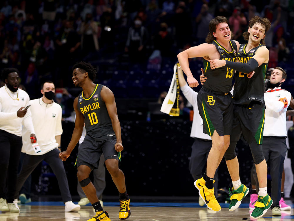 Baylor players (from left) Adam Flagler, Jackson Moffatt and Matthew Mayer celebrate after defeating the Gonzaga Bulldogs in the National Championship game of the 2021 NCAA Men's Basketball Tournament at Lucas Oil Stadium.