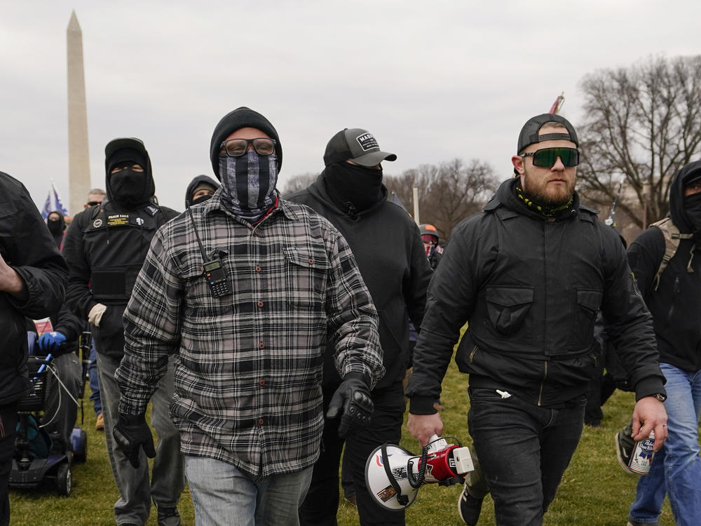 Joe Biggs (left) and Ethan Nordean (right) walk toward the U.S. Capitol on Jan. 6. Members of the Proud Boys, including Biggs and Nordean, have become central targets of the Justice Department's sprawling investigation into the Capitol riot.