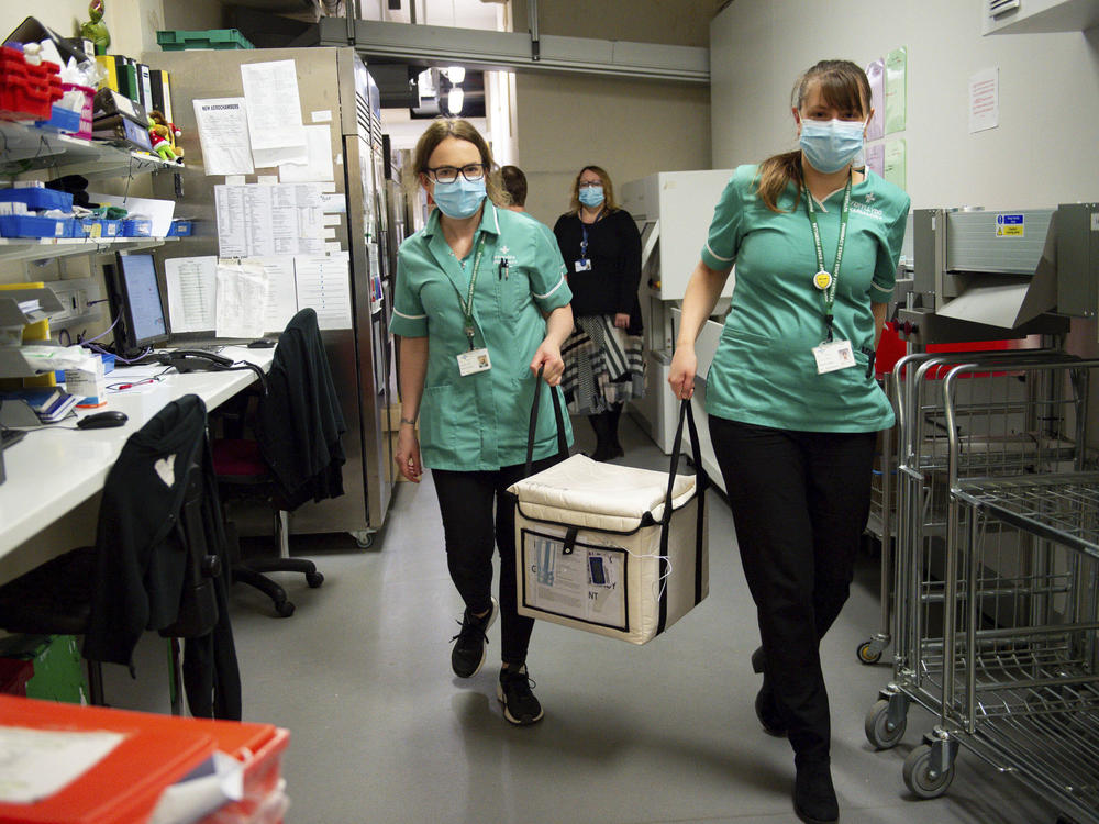 On Wednesday, pharmacists at the West Wales General Hospital in Carmarthen, Wales, transport a cool box containing the first batch of Moderna vaccines being distributed in Britain.