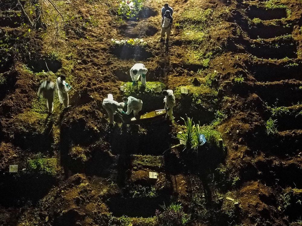 A coffin is buried at the Vila Formosa cemetery in Sao Paulo, Brazil, late last month. Brazil has been experiencing record numbers of coronavirus infections and COVID-19 deaths in recent weeks.