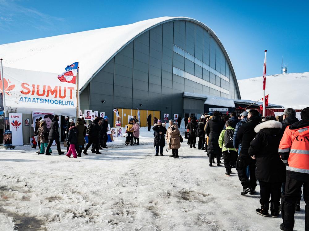Voters stand in line to cast ballots Tuesday for Greenland's parliamentary elections at a polling station in the capital.