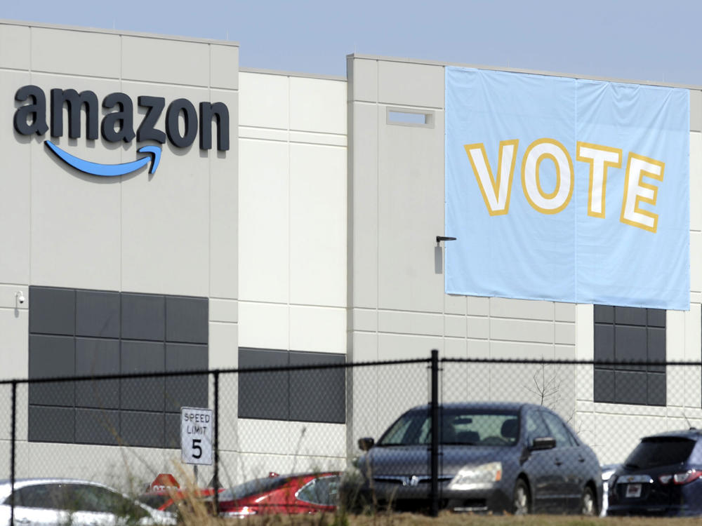 A banner encourages workers to vote in a union election at Amazon's warehouse in Bessemer, Ala.