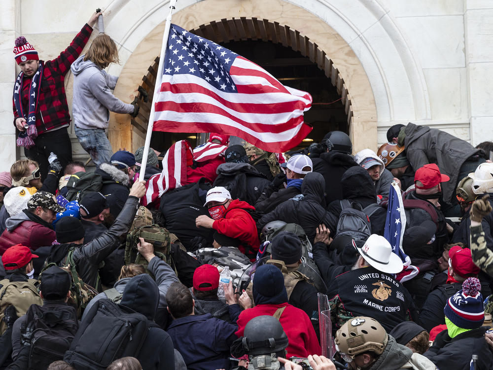 Rioters clash with police trying to enter Capitol building through the front doors. Rioters broke windows and breached the Capitol building in an attempt to overthrow the results of the 2020 election.