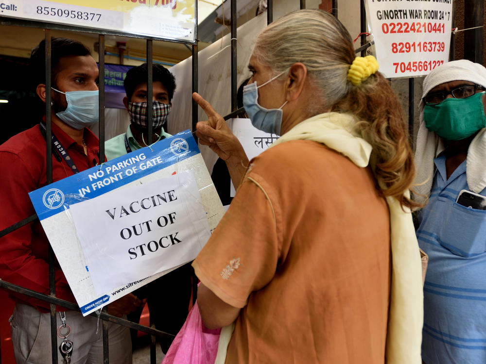 A public notice hangs outside a vaccination center notifying of vaccine shortages in Mahim, in Mumbai, India, on Thursday.