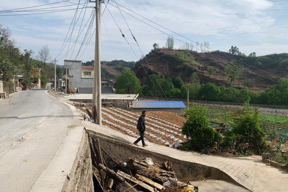 Mengzhu's father Chen Wanhua walking in his hometown in Bijie, a prefecture in China's Guizhou province. Chen raised Mengzhu and his two sisters on his own after his wife walked out on the family.