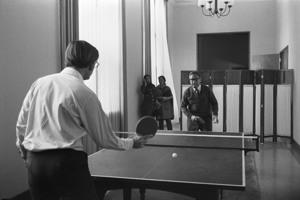 National Security Adviser Henry Kissinger (right) plays pingpong with aide Winston Lord during an advance trip to the People's Republic of China in 1971.