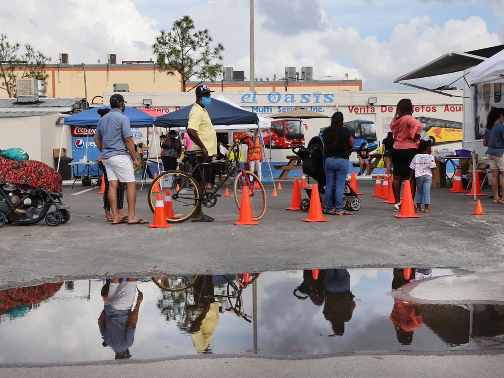 People line up to receive a rapid COVID-19 test on Feb. 17, 2021 in Immokalee, Fla. Immokalee, which has a poverty rate of around 40% and whose population is made up primarily of agricultural workers, has joined with the Coalition of Immokalee Workers and Partners in Health to test, educate and vaccinate the community during the COVID-19 outbreak.