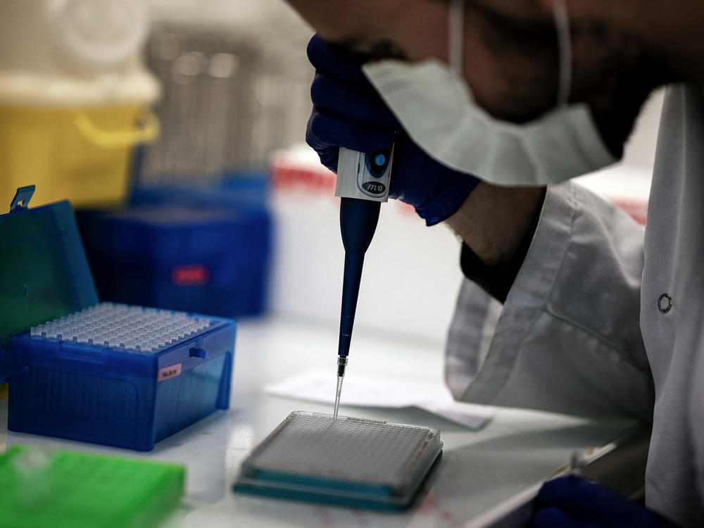 A scientist works on COVID-19 samples to find variations of the virus at the Croix-Rousse Hospital laboratory in Lyon, France, in January.