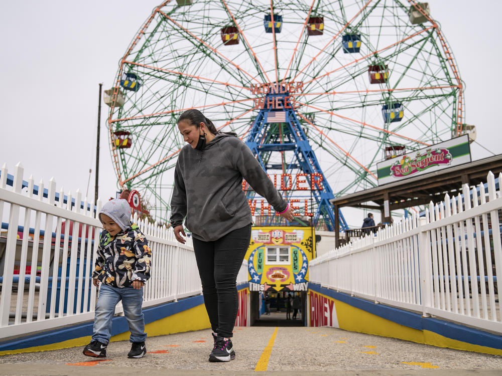 Visitors leave the Wonder Wheel ride after the re-opening of Coney Island's amusement parks on Friday.