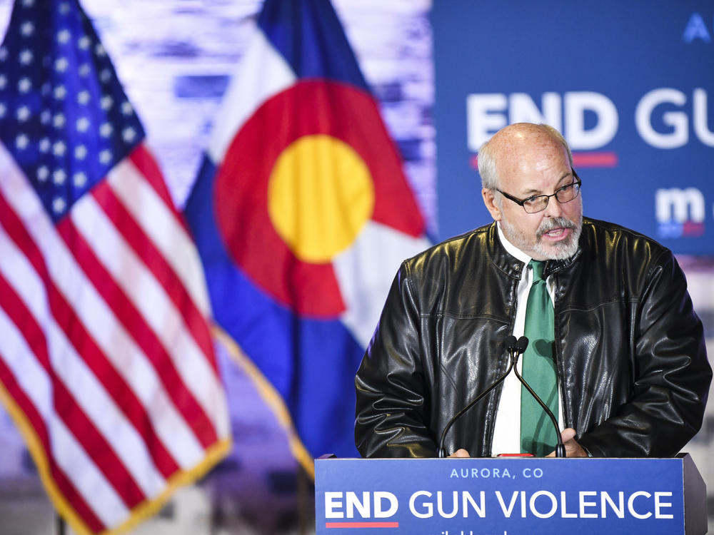 Colorado state Rep. Tom Sullivan, pictured here in 2019 introducing former Democratic presidential candidate Michael Bloomberg, says now is not the time to push for a statewide ban on assault-style weapons.