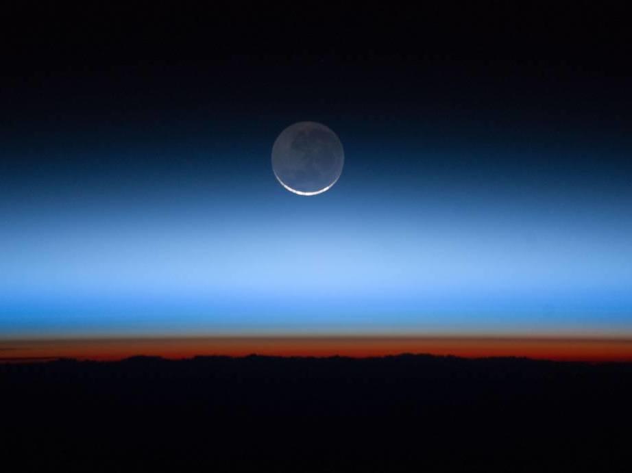 Earth's atmosphere photographed from the International Space Station. Greenhouse gases have accumulated rapidly and are trapping extra heat in the atmosphere. It will take decades for the gases to break down naturally or be reabsorbed on Earth's surface.