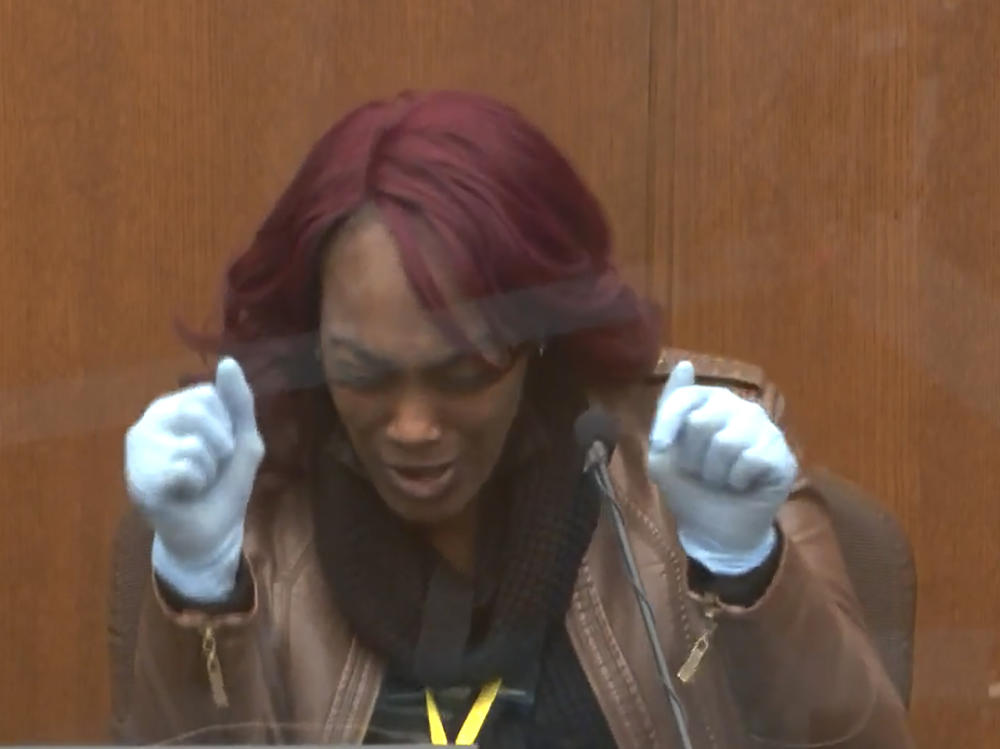 Shawanda Hill testifies Tuesday in the trial of Derek Chauvin. She said that as a police officer stood with a gun drawn outside the car she was in with George Floyd, Floyd grabbed the steering wheel and started saying, 