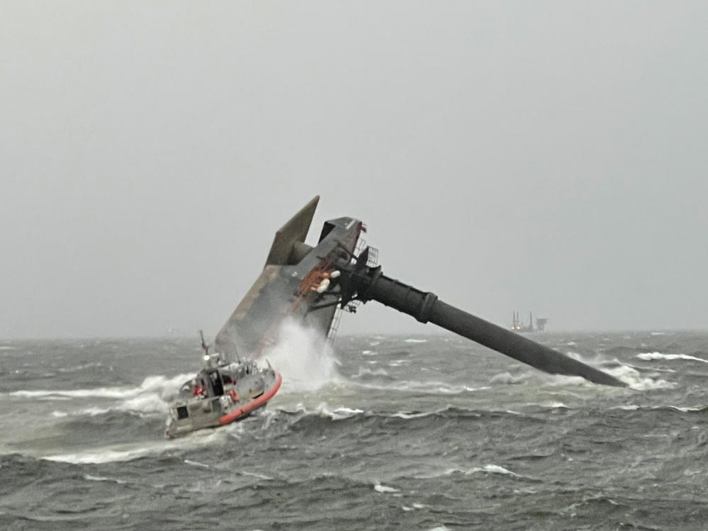 A Coast Guard Station Grand Isle boat crew heads toward a capsized commercial lift boat April 13 searching for people in the water 8 miles south of Grand Isle, Louisiana.